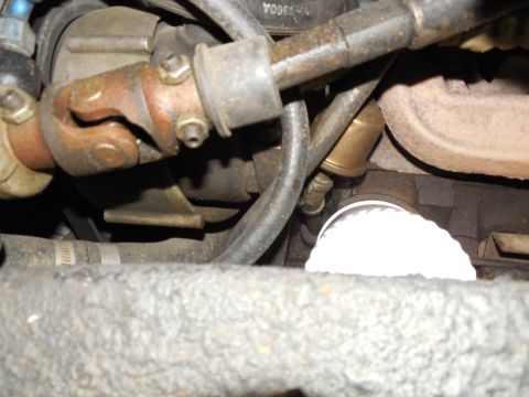 1975 Ford Bronco - Looking R from the LHF tire at the Saginaw pump, oil pressure sender, oil filter, & L ex.man.