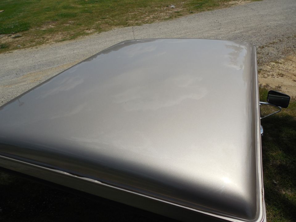 Those are reflections of clouds & trees - the paint is immaculate.