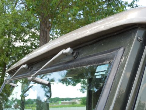 1975 Ford Bronco - Close-up view of the windshield wipers and frame of an unidentified vehicle.