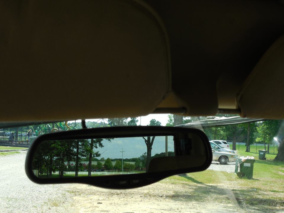 I realized too late that I took this pic with the spare swung OUT instead of latched.  It does block the rear view noticeably, but not so much that it's unsafe.  The rear-view camera (not currently installed) does help.