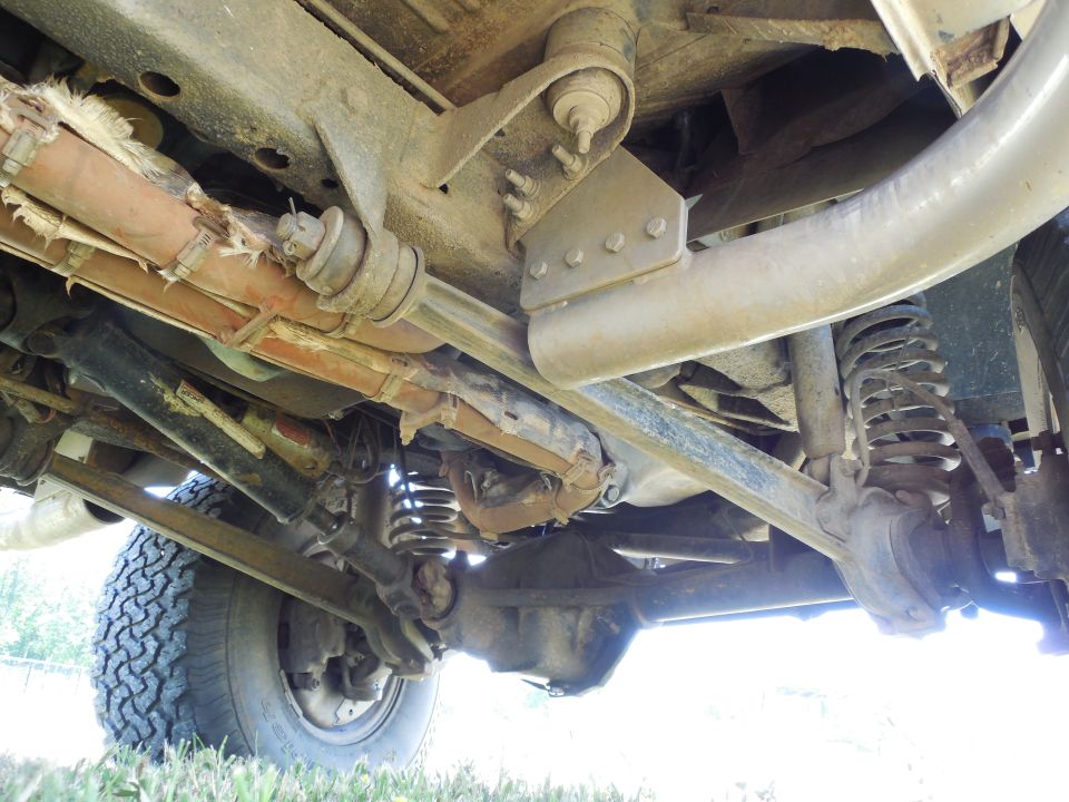 RHS looking forward under the frame.

Note the extra holes on the bottom face of the frame behind the radius arm nut which I added to install the nuts for the relocated crossmember.  They also drain the frame effectively.