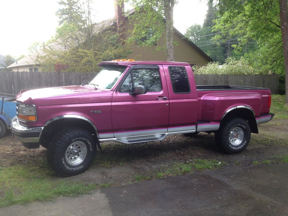 Pink 1992 Ford F-150 pickup truck with chrome accents and aftermarket wheels, parked outdoors