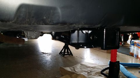 2014 Subaru Outback - A trailer hitch receiver is installed on the underside of a vehicle, with jack stands providing support.