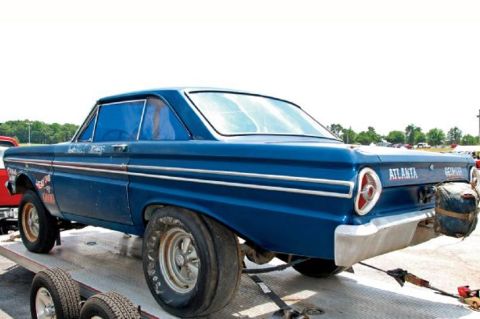 1968 Ford Mustang - A blue 1963 Ford Falcon drag car is seen from the rear, loaded onto a trailer.