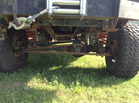 1995 Ford Bronco - The front suspension and steering components of a heavily modified off-road vehicle are visible.
