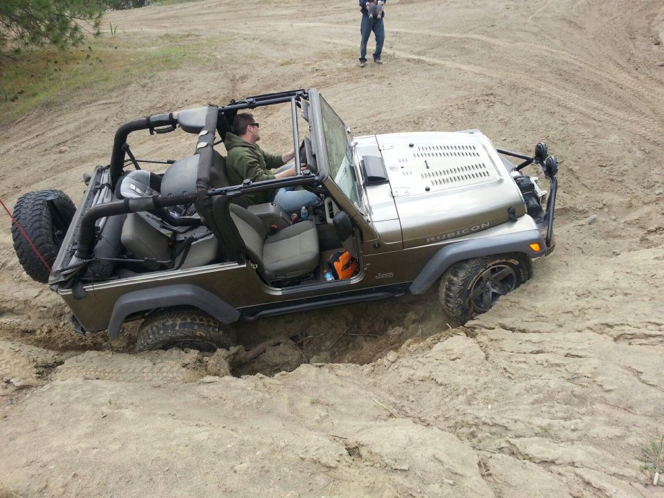 Brown 2005 Jeep Wrangler stuck in sand, Rubicon model