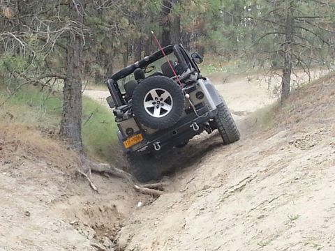 2005 Jeep Wrangler - A Jeep Wrangler navigates a steep, sandy incline on an off-road trail.