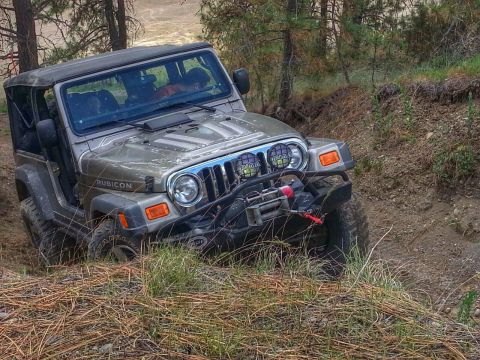 2005 Jeep Wrangler - Jeep Wrangler Rubicon navigating a challenging off-road trail with steep inclines.