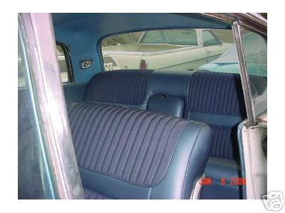 1960 Lincoln Premiere - The interior of a 1960 Lincoln Premiere shows blue ribbed seats, with another vehicle visible outside.
