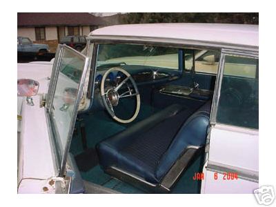 1960 Lincoln Premiere - The interior of a white car is visible with blue seats and a white steering wheel, along with a watermark indicating it was posted on Janua…