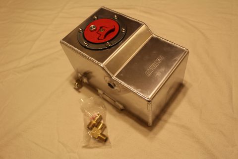 2003 Ford Crown Victoria - welded polished aluminum fluid reservoir tank with a red flush-mount filler cap and a bag of brass fittings beside it.