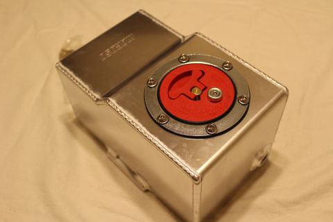 2003 Ford Crown Victoria - Top angle of a welded aluminum fuel cell with a round red flip-up billet filler cap secured by six bolts.