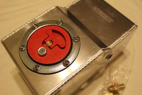 2003 Ford Crown Victoria - Angled top view of a welded aluminum fuel cell with a red flip-up billet cap and an embossed Moroso logo on the side.