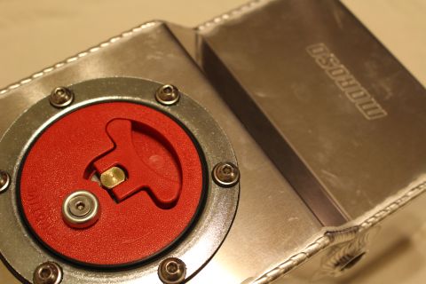 2003 Ford Crown Victoria - Close top view of a welded aluminum fuel cell with a red billet flip-up cap and Moroso branding embossed on the side panel.