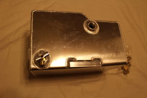 2003 Ford Crown Victoria - Rear view of a welded aluminum fuel cell with raised welded bungs, a recessed flush handle and visible seam welds.