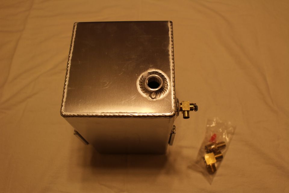 End view of aluminum fuel cell with welded bung, brass fitting and bagged parts