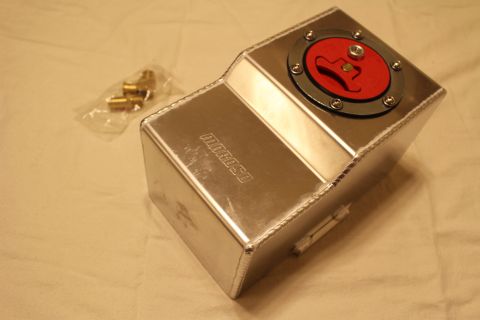 2003 Ford Crown Victoria - brushed aluminum fuel cell shows a red flip-top quick-fill cap and an embossed Moroso logo, with brass fittings in a plastic bag alongside.
