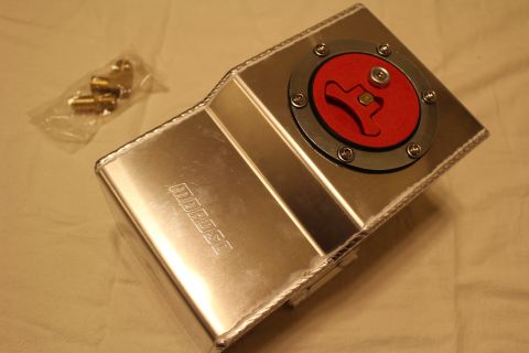 2003 Ford Crown Victoria - aluminum fuel cell with a red Moroso quick-fill cap is photographed from above beside a bag of brass fittings.