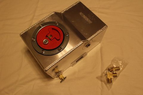 2003 Ford Crown Victoria - aluminum fuel cell with a red quick-fill cap and a brass valve bung rests near two bags of brass fittings on a white sheet.