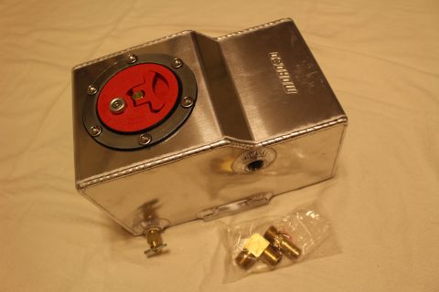 2003 Ford Crown Victoria - aluminum fuel cell with a red quick-fill cap and threaded side bungs sits beside a bag of brass fittings.