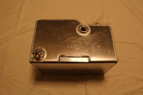 2003 Ford Crown Victoria - Top view of a brushed aluminum fuel cell with welded threaded bungs, a brass petcock valve, and a blank label plate.