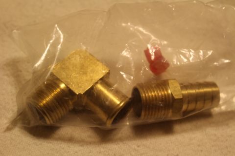 2003 Ford Crown Victoria - Two brass plumbing fittings, a 90-degree elbow and a threaded hose barb, sit inside a clear plastic bag.