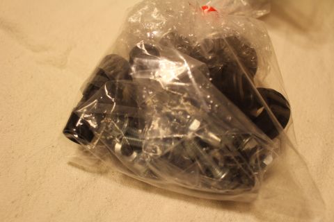 2003 Ford Crown Victoria - clear plastic bag is filled with black bushings and an assortment of plated bolts and fasteners.