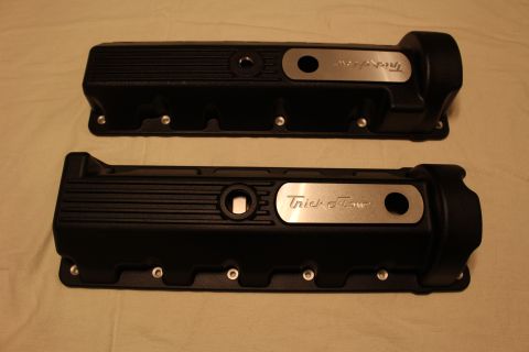 2003 Ford Crown Victoria - pair of black finned valve covers laid on cloth, each carrying a brushed aluminum plate engraved with the Trick Flow name.
