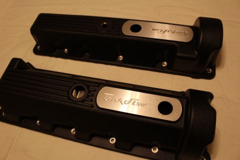 2003 Ford Crown Victoria - Two black finned valve covers shown from the top, each fitted with a brushed aluminum Trick Flow nameplate and oil-fill hole.