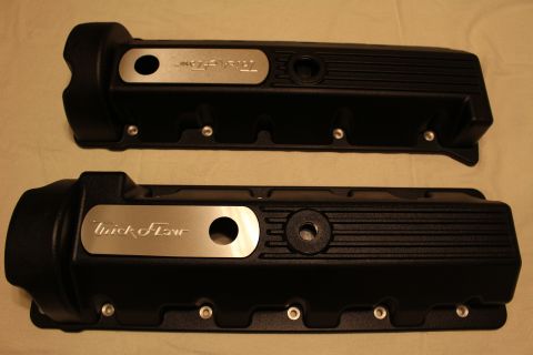 2003 Ford Crown Victoria - pair of black finned valve covers on a tan cloth, each fitted with a brushed aluminum plate engraved with Trick Flow.