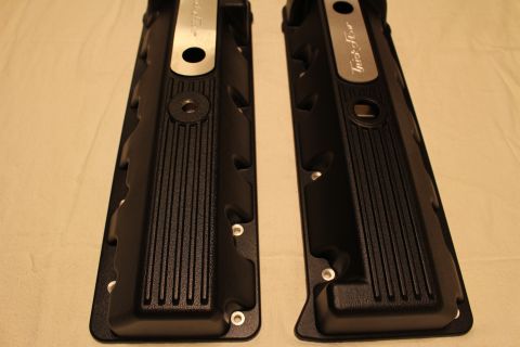 2003 Ford Crown Victoria - Detail of two black finned valve covers showing ribbed sides and partly visible brushed aluminum Trick Flow nameplates.