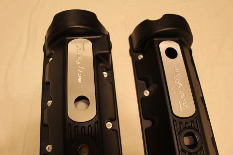 2003 Ford Crown Victoria - Detail of two black valve cover ends with rounded caps and brushed aluminum nameplates engraved Trick Flow.