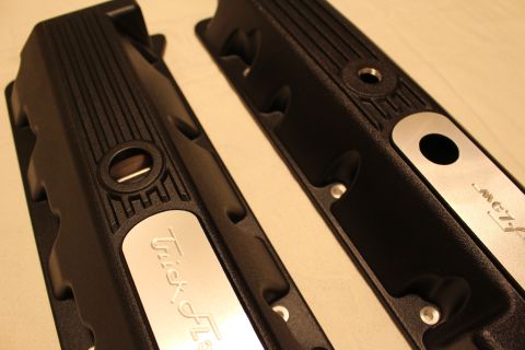 2003 Ford Crown Victoria - Two black finned engine valve covers with polished aluminum Trick Flow accent plates resting on a cloth surface.