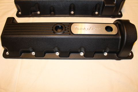 2003 Ford Crown Victoria - black ribbed valve cover featuring an oil-fill opening and a polished Trick Flow logo plate, on a tan cloth.
