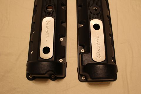 2003 Ford Crown Victoria - Top-down view of two black valve covers with polished aluminum Trick Flow accent plates on a tan cloth.