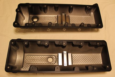2003 Ford Crown Victoria - Underside view of two black valve covers showing internal baffles, gasket rails, and cast TFS markings.