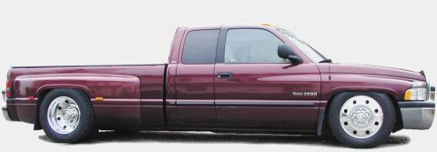 1978 Ford Bronco - Side profile of a lowered maroon Dodge Ram 3500 pickup truck dual rear wheels and a crew cab.