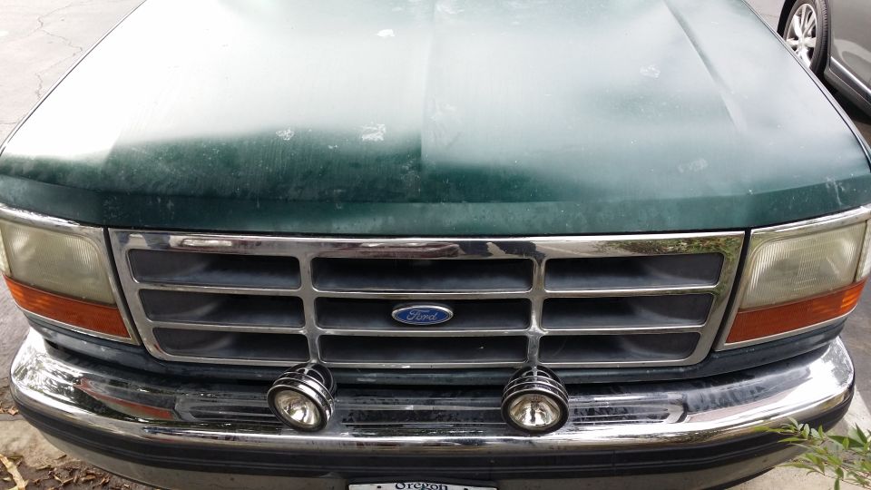 1992 Ford F-Series truck grille with Ford oval emblem and two aftermarket fog lights