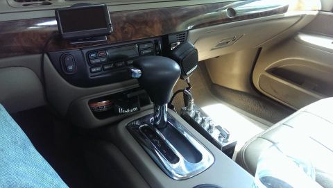 2000 Mercury Grand Marquis - The interior of a 2000 Mercury Grand Marquis shows wood trim, a CB radio, and a GPS device.