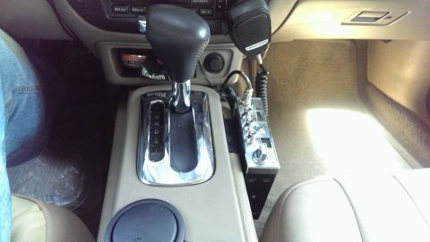 2000 Mercury Grand Marquis - The interior center console of a 2000 Mercury Grand Marquis features a CB radio and automatic gear shifter.
