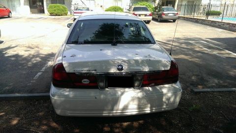 2000 Mercury Grand Marquis - Rear view of a white 2000 Mercury Grand Marquis LSE parked in a lot.