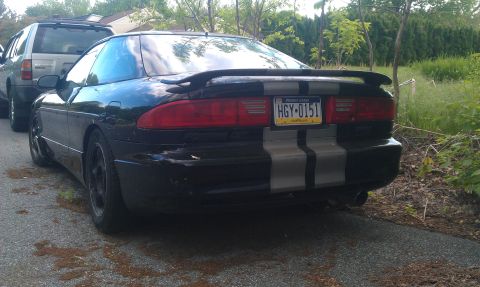 1993 Ford Probe - This black coupe features prominent silver racing stripes on its rear.