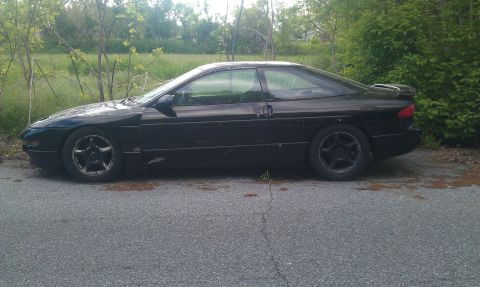 1993 Ford Probe - Side profile of a black 1993 Ford Probe GT coupe.