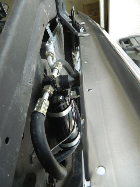 1979 Ford Bronco - Close-up view of an AC accumulator assembly, showing hoses and mounting hardware.