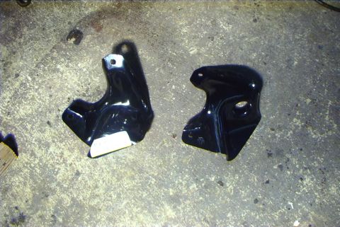 1995 Ford Bronco - Two black metal lift kit brackets are shown on a concrete surface.