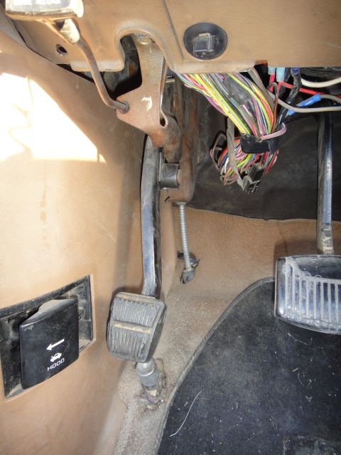 1988 Ford Bronco - Interior view of a 1988 Ford Bronco's footwell, highlighting pedals and wiring.