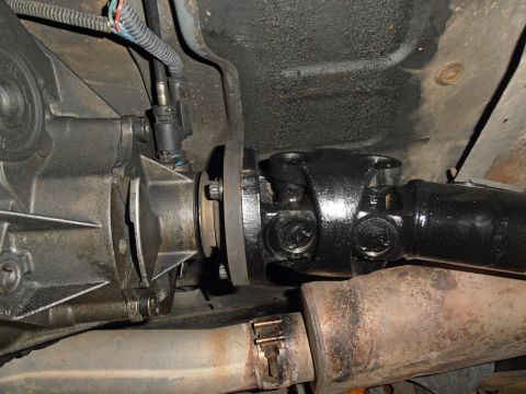 1990 Ford Bronco - Close-up view of the undercarriage showing the transfer case and driveshaft connection.