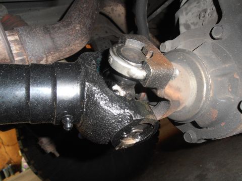 1990 Ford Bronco - Close-up view of a driveshaft universal joint, showing a grease fitting for maintenance.