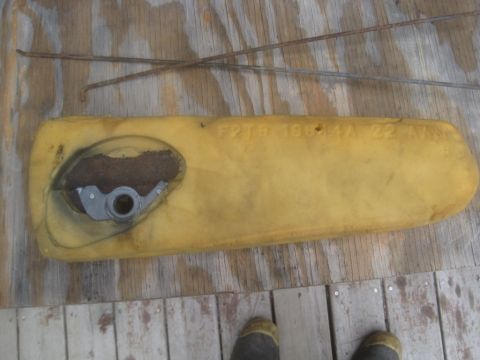 1993 Ford Bronco - This yellow foam part, possibly from a vehicle interior, has a metal mechanism and visible text 'F2TB 19G44 AA 22A'.
