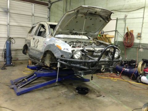1999 Isuzu Vehicross - This 1999 Isuzu Vehicross is on a lift with its hood open, showing off its off-road modifications and front-end details.